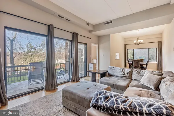 a spacious bedroom with a bed and glass window