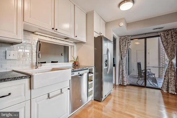 a kitchen with a refrigerator stove and cabinets