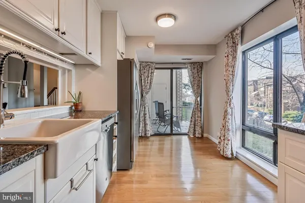 a spacious bathroom with a granite countertop sink mirror and a bathtub