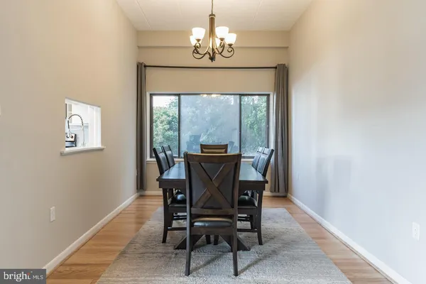 a dining room with furniture a chandelier and a rug