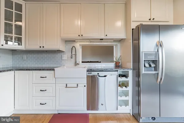 a kitchen with stainless steel appliances granite countertop a refrigerator and cabinets