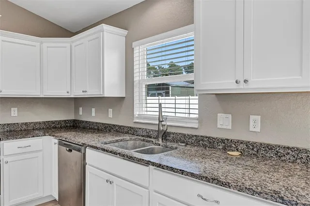 a kitchen with stainless steel appliances granite countertop a refrigerator stove and microwave