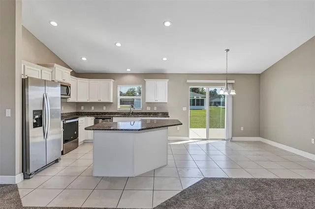 a view of a kitchen with microwave and cabinets