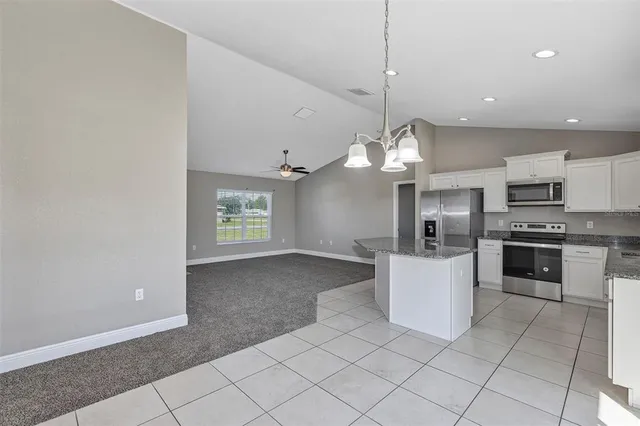a kitchen with granite countertop white cabinets and a granite counter tops