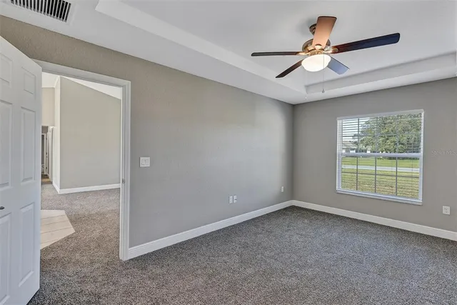 an empty room with closet and windows
