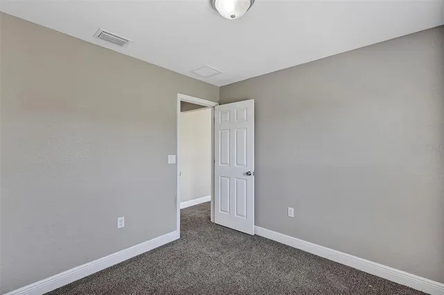 a bathroom with a granite countertop bathtub sink vanity mirror and toilet