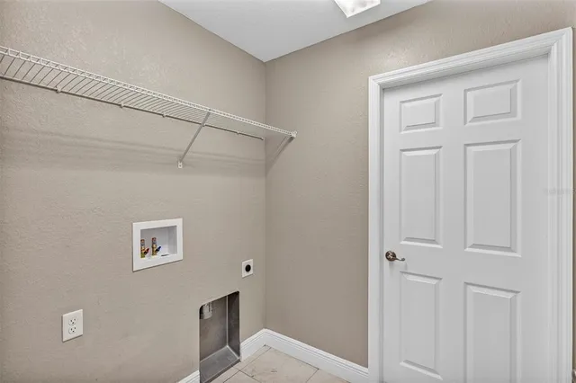 a view of a yard in front of a house with a large tree