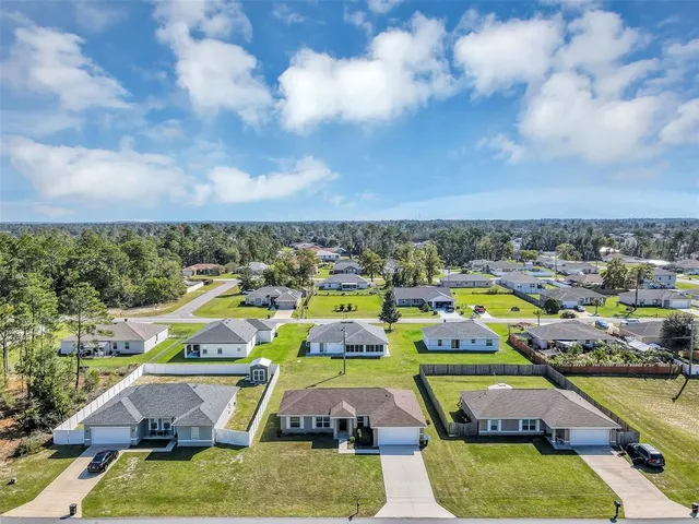 a view of a swimming pool with a yard