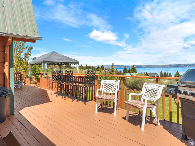 371 Lewis Loop, Unit 29 Fish Haven, ID 83287 - Photo 3 of 40 Expansive outdoor deck with a warm wood-finish surface, offering a broad water expanse backdrop