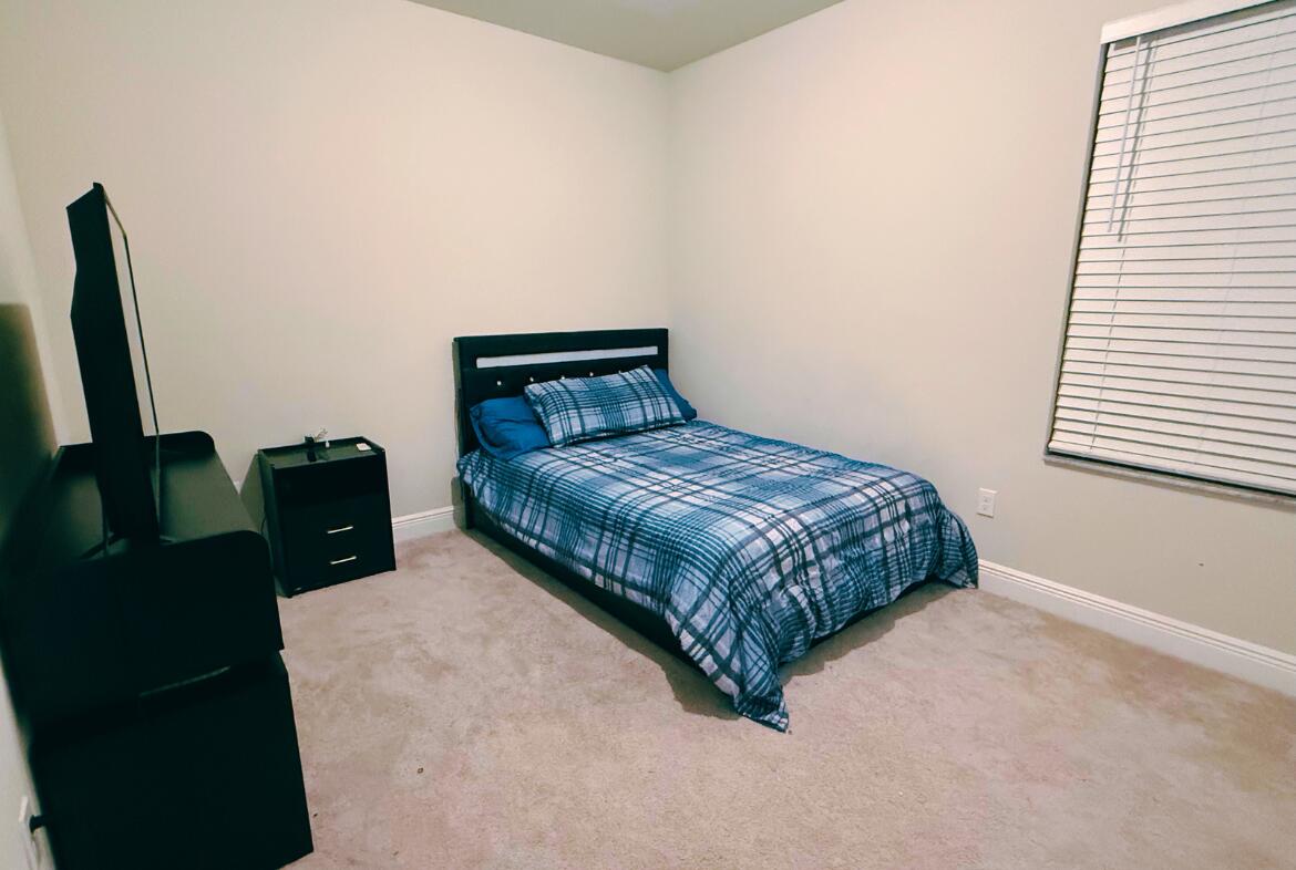 11024 Pacini Way Port St. Lucie, FL 34987 - Photo 12 of 16 a bedroom with a bed and wooden floor