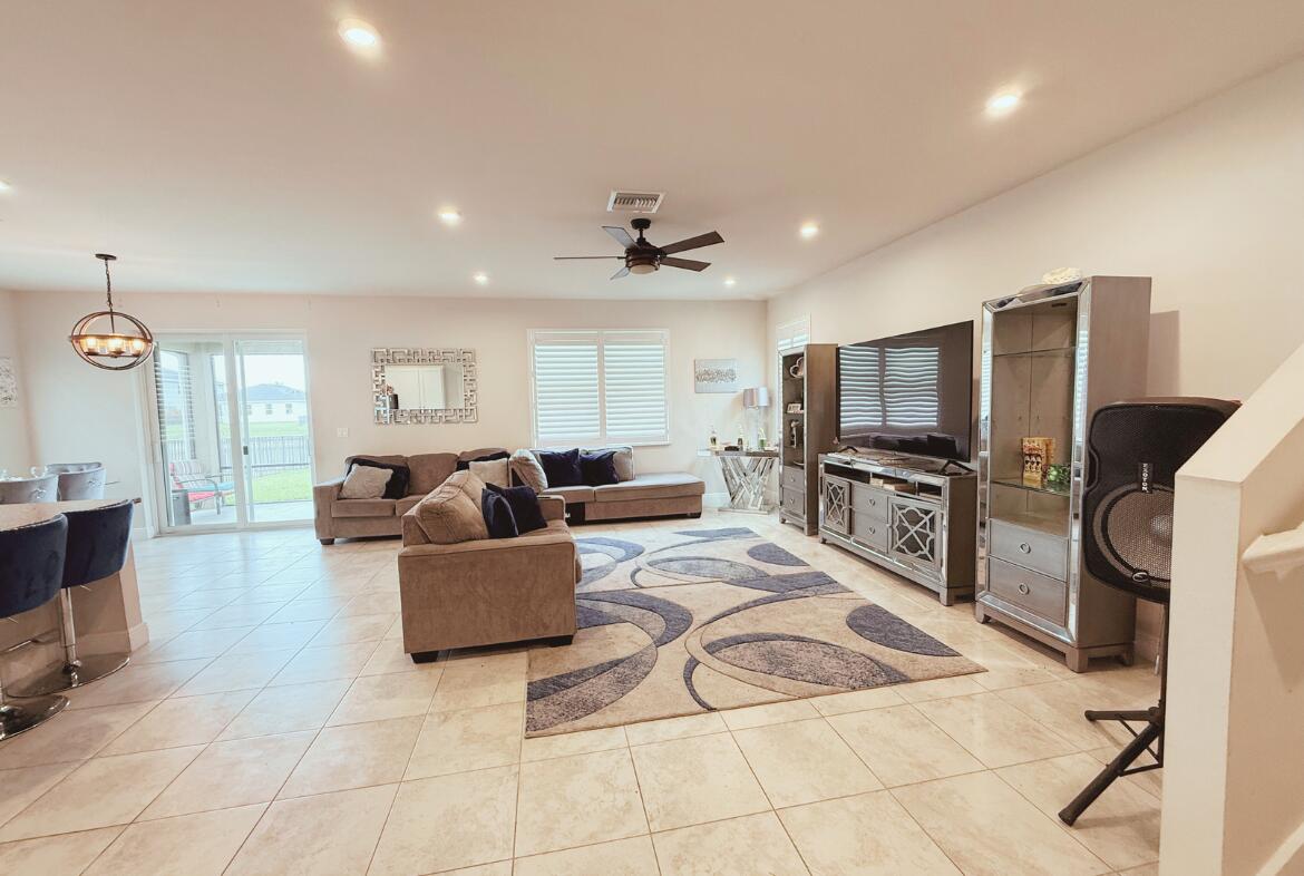 11024 Pacini Way Port St. Lucie, FL 34987 - Photo 13 of 16 a living room with furniture and a flat screen tv