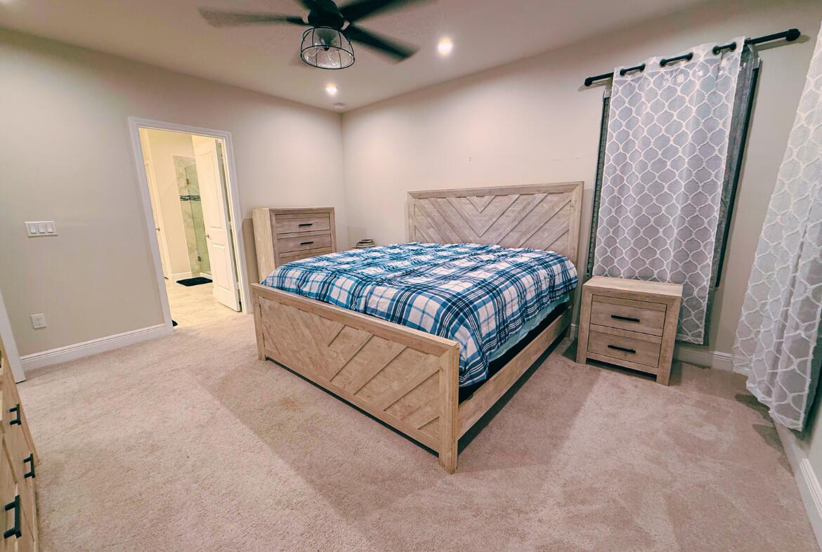 11024 Pacini Way Port St. Lucie, FL 34987 - Photo 3 of 16 a bed sitting in a bedroom and table