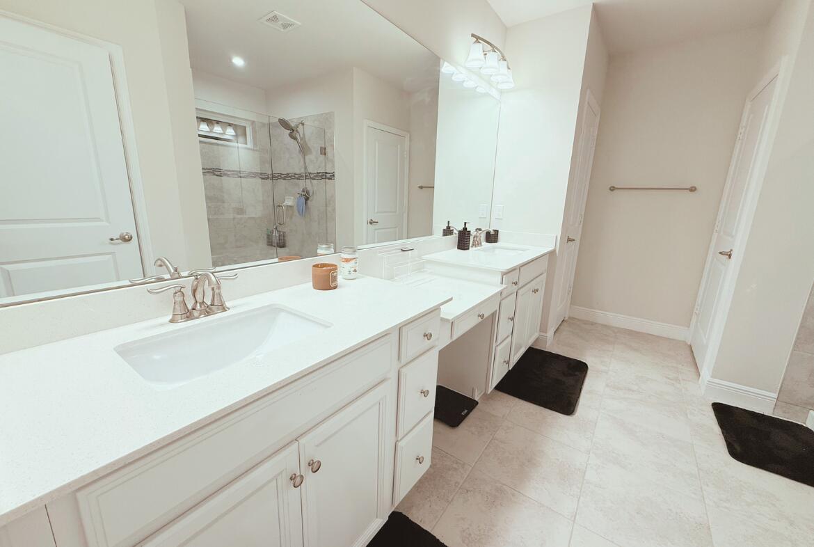 11024 Pacini Way Port St. Lucie, FL 34987 - Photo 4 of 16 a bathroom with a sink double vanity and a mirror