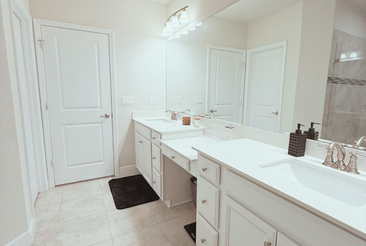 11024 Pacini Way Port St. Lucie, FL 34987 - Photo 6 of 16 a spacious bathroom with a sink and a mirror