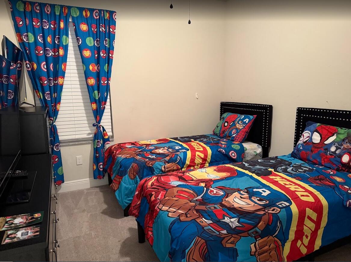 11024 Pacini Way Port St. Lucie, FL 34987 - Photo 7 of 16 a bedroom with two beds and a lamp