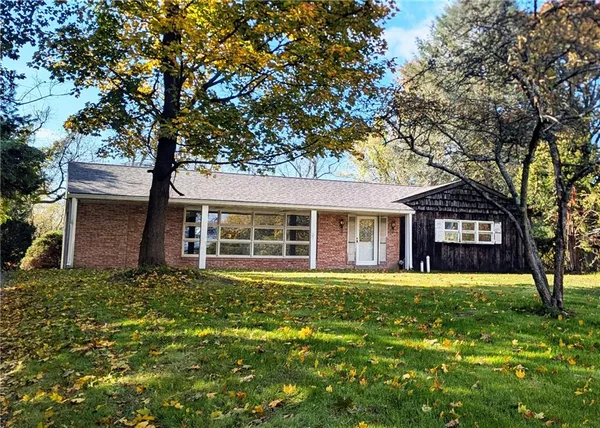 front view of a house with a tree