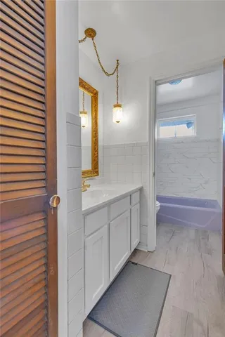 a spacious bathroom with a mirror and a shower