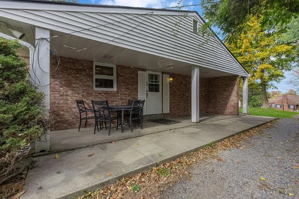 a view of a house with patio and a yard