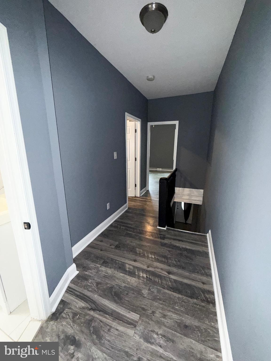 2324 North Lambert Street Philadelphia, PA 19132 - Photo 11 of 13 a view of a hallway to a house with wooden floor and furniture