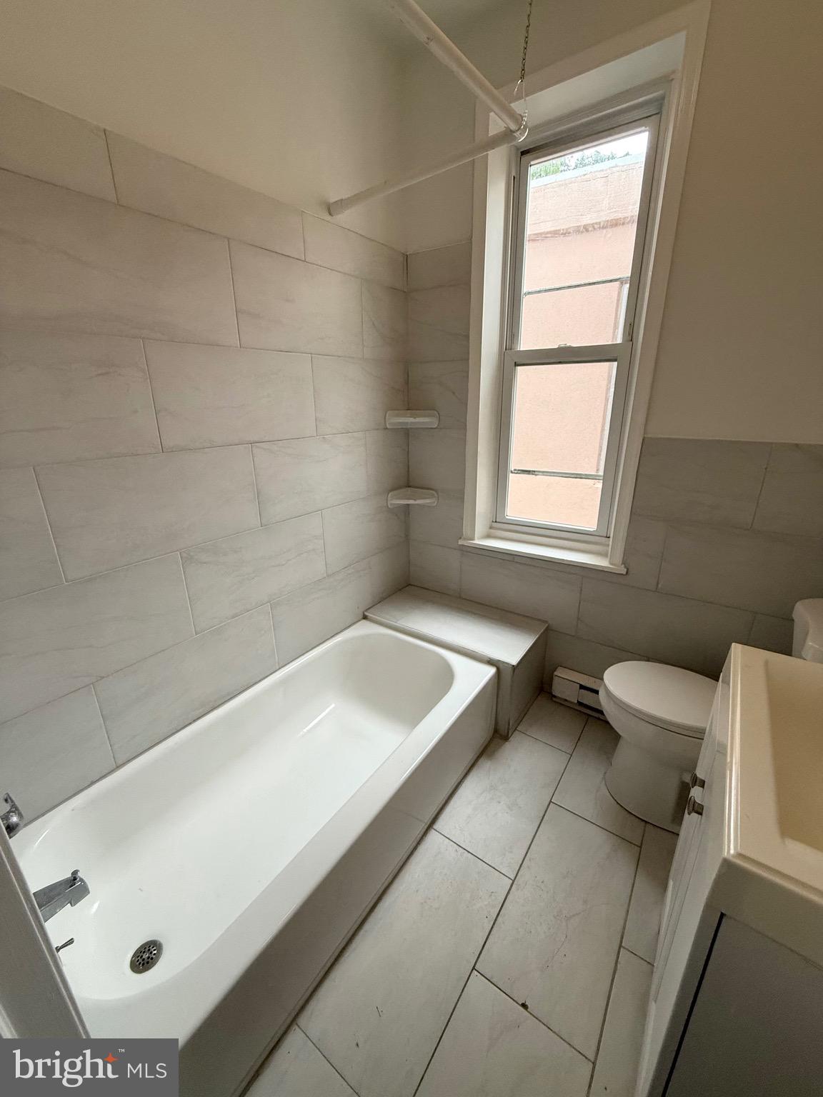 2324 North Lambert Street Philadelphia, PA 19132 - Photo 8 of 13 a bathroom with a tub and window
