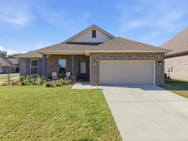 a front view of a house with yard patio and green space