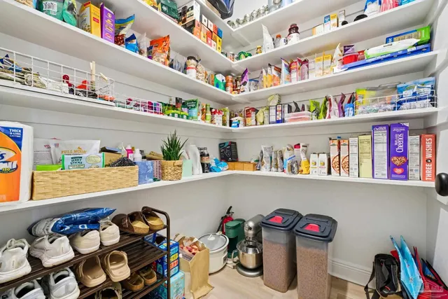 a room with furniture a baby crib and a couch