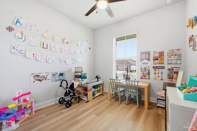 a view of a bedroom with baby crib and furniture