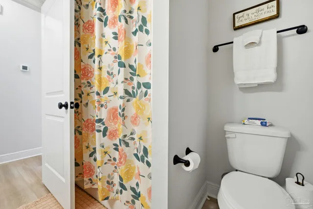 a bedroom with a bed and a flat tv screen on dresser