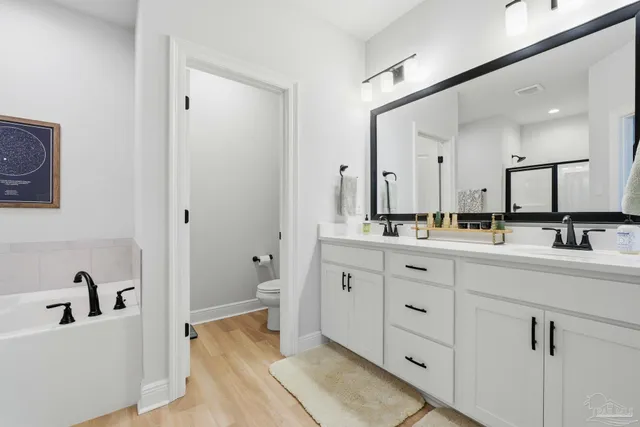 a bathroom with a double vanity sink and a mirror