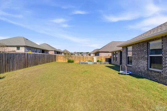 a view of a house with backyard sitting area and garden