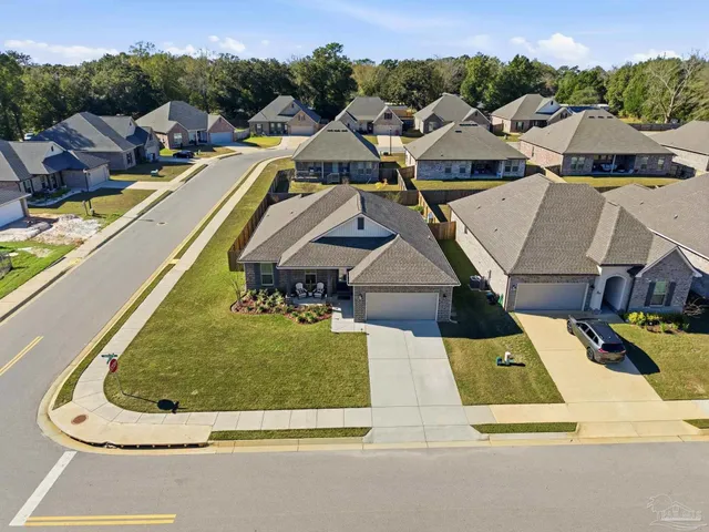 an aerial view of residential houses with outdoor space