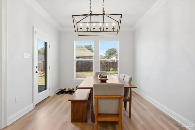 a view of a dining room with furniture and a chandelier