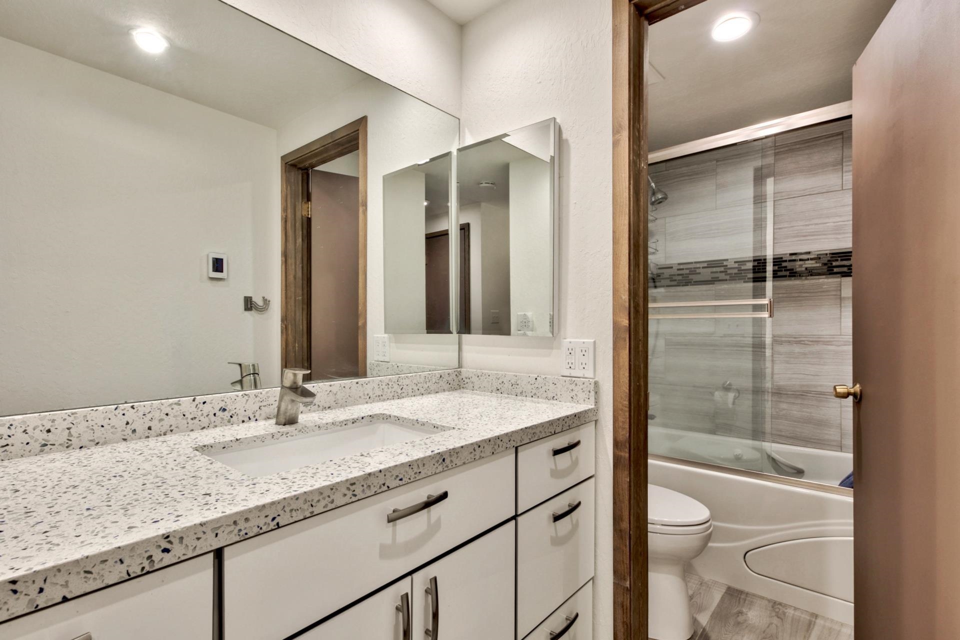 2755 North Lake Boulevard, Unit 9 Tahoe City, CA 96145 - Photo 14 of 21 a bathroom with a granite countertop sink and a mirror