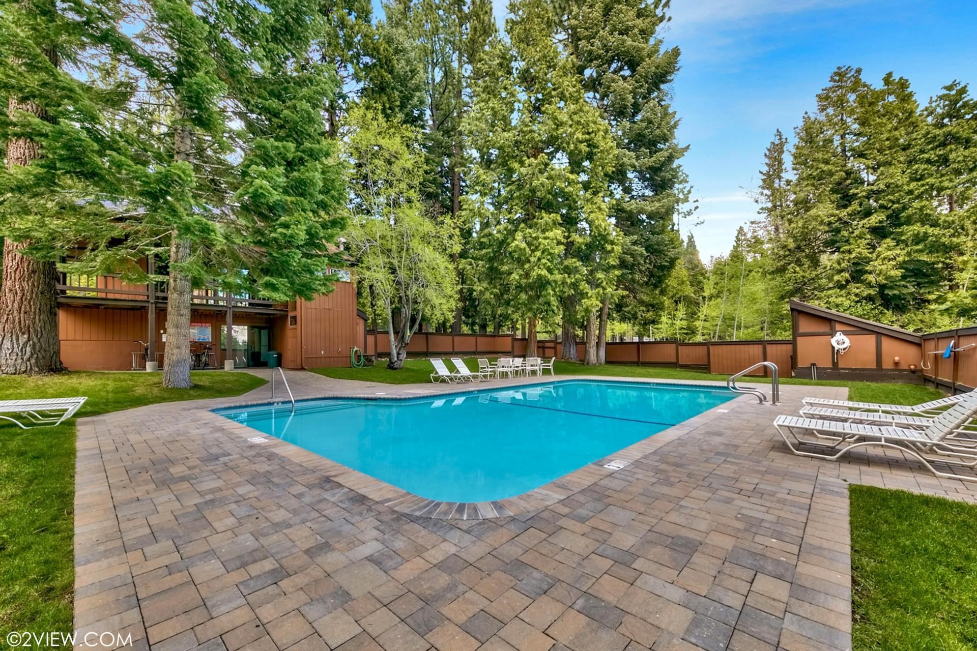 2755 North Lake Boulevard, Unit 9 Tahoe City, CA 96145 - Photo 19 of 21 a view of a swimming pool with a chair and tables in the yard