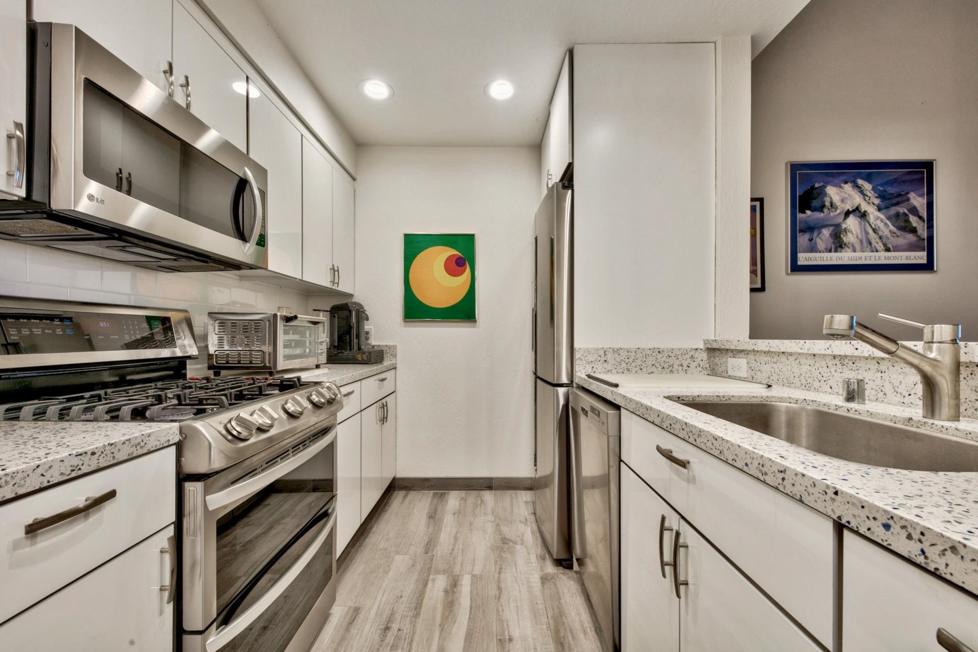 2755 North Lake Boulevard, Unit 9 Tahoe City, CA 96145 - Photo 5 of 21 a kitchen with stainless steel appliances granite countertop a stove and a sink