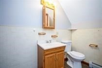 315 Woronoco Road Russell, MA 01071 - Photo 36 of 42 a bathroom with a sink a toilet and a mirror
