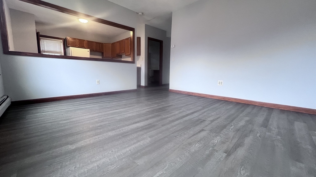 315 Woronoco Road Russell, MA 01071 - Photo 10 of 42 a view of an empty room with wooden floor and a window