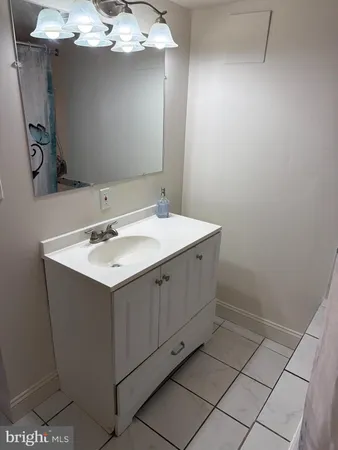 a bedroom with a bed and a large mirror