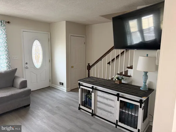 a view of an entryway with wooden floor