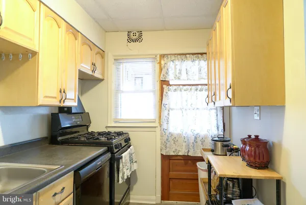 a kitchen with a stove a sink and a refrigerator