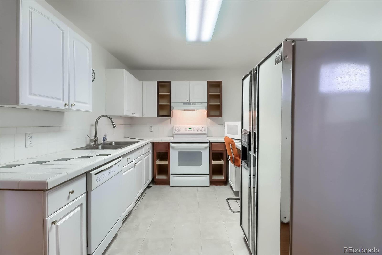 40273 County Road 13 Elizabeth, CO 80107 - Photo 16 of 40 a kitchen with stainless steel appliances a sink stove and refrigerator