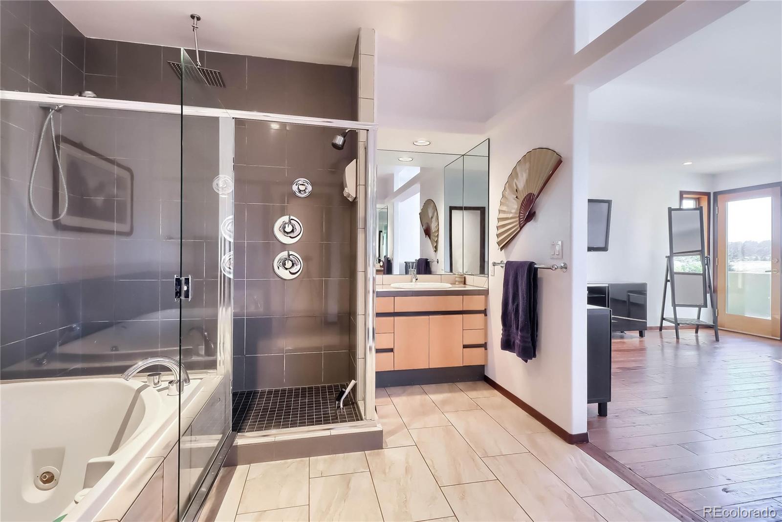 40273 County Road 13 Elizabeth, CO 80107 - Photo 29 of 40 a bathroom with a tub a sink and a shower