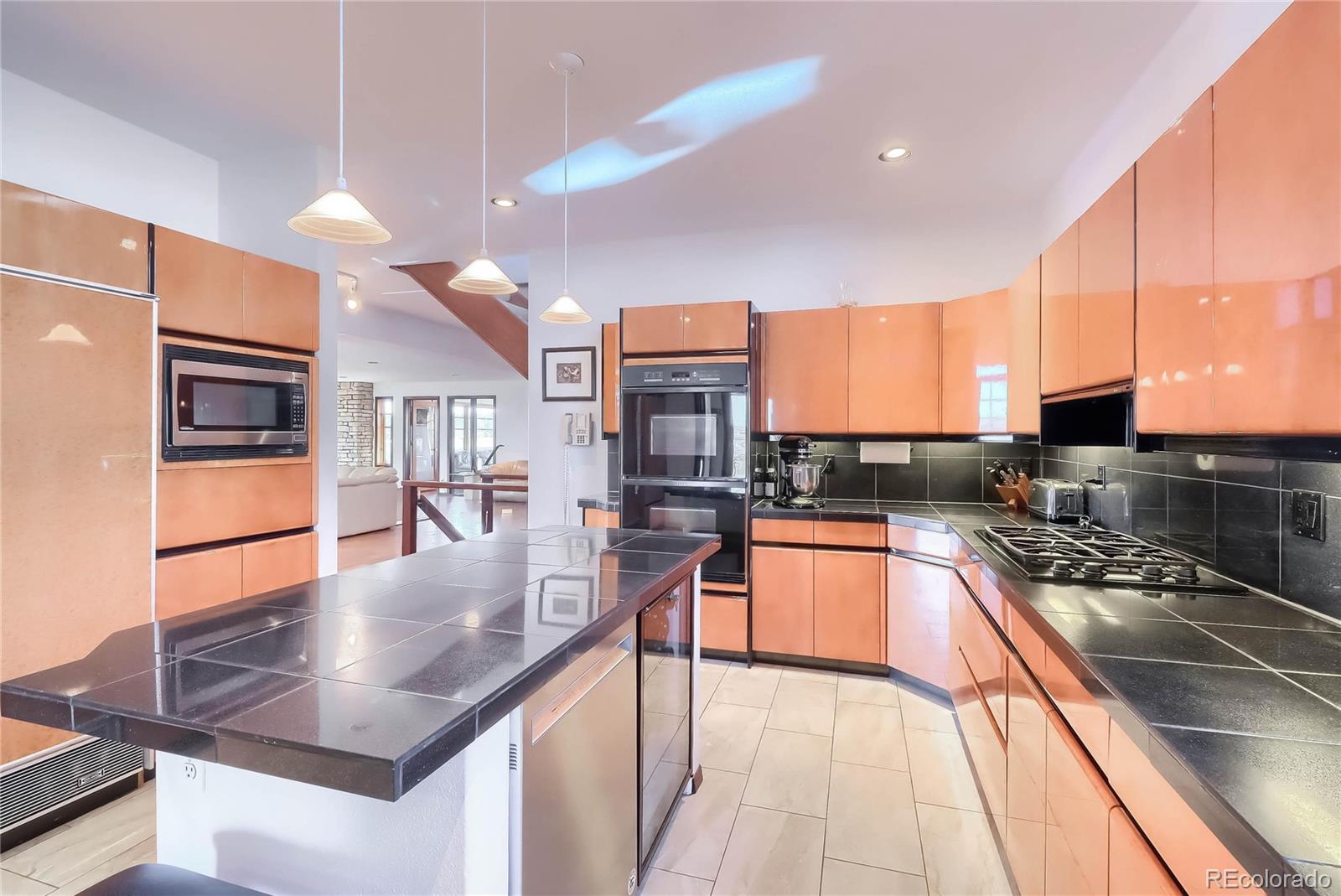 40273 County Road 13 Elizabeth, CO 80107 - Photo 31 of 40 a view of a kitchen with kitchen island a large counter top space a sink stainless steel appliances and cabinets
