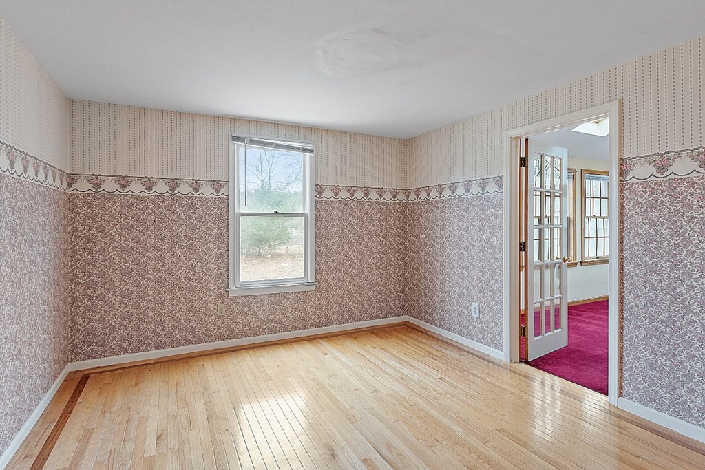 885 Townsend Road Groton, MA 01450 - Photo 25 of 39 a view of empty room with wooden floor and fan