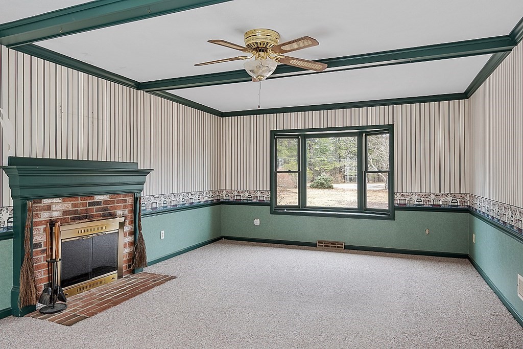 885 Townsend Road Groton, MA 01450 - Photo 34 of 39 an empty room with a fireplace and windows