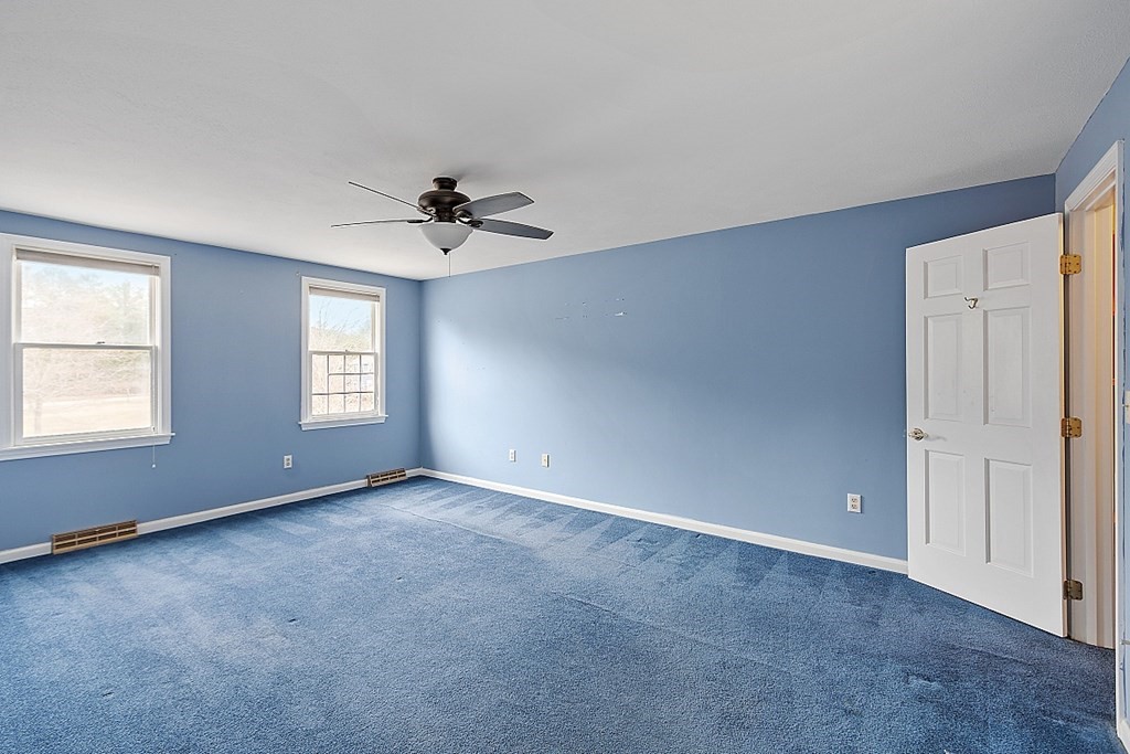 885 Townsend Road Groton, MA 01450 - Photo 8 of 39 an empty room with windows and fan
