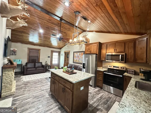 a kitchen with sink stove and refrigerator