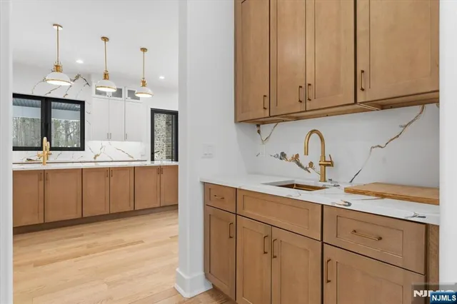 a kitchen with kitchen island granite countertop a sink stainless steel appliances and cabinets