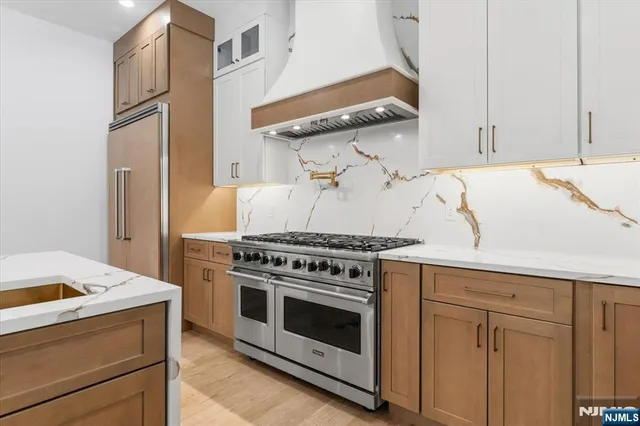 a stove top oven sitting inside of a kitchen