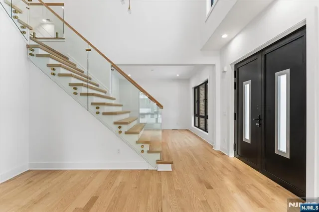a view of entryway and hall with wooden floor